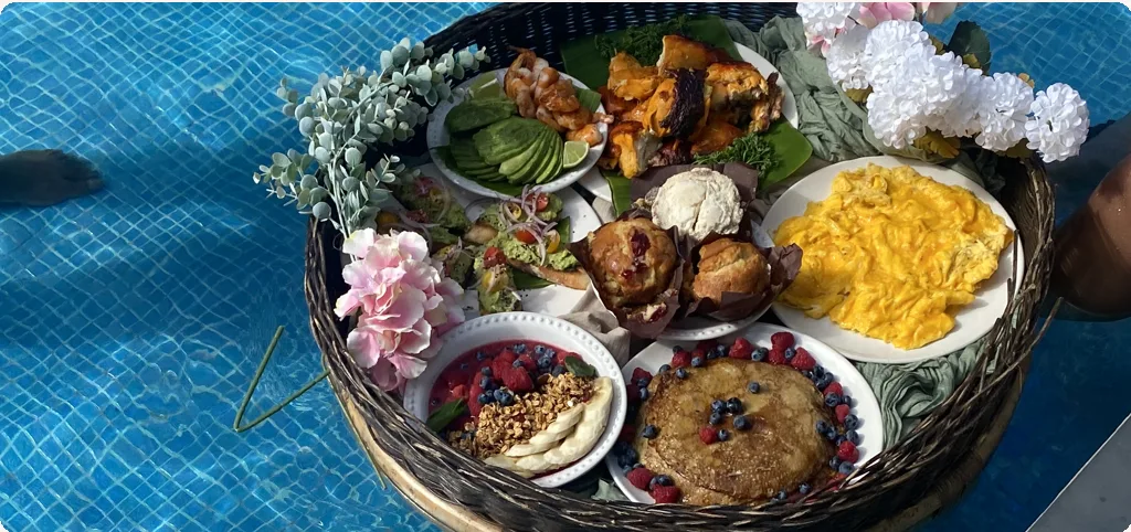 Floating breakfast tray decorated with flowers on the pool, Habanero's Private Chef Tulum